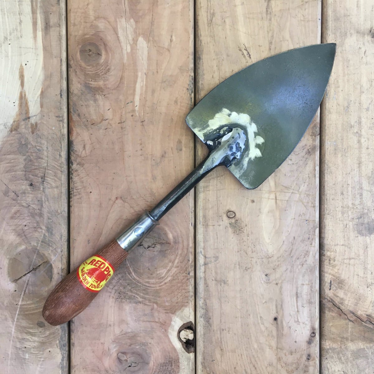 A flat bladed trowel for setting bulbs and light dividing of iris, lily, and other spreading plants.
