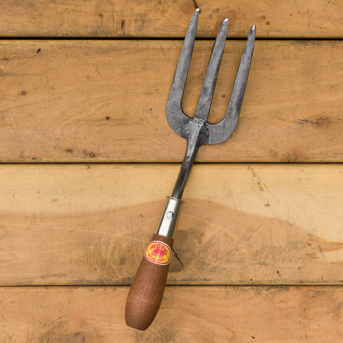 A gardening hand fork with flat tines for maintaining well cultivated soil.