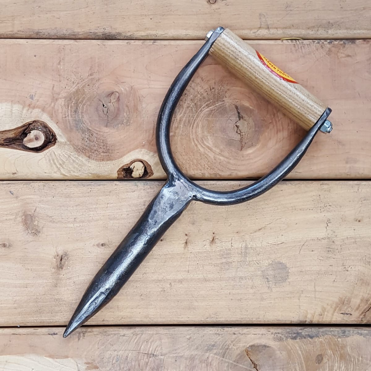 A dibble or dibber or dibbler is a heavy duty hole maker. Stick it in the ground and wiggle to make a planting hole