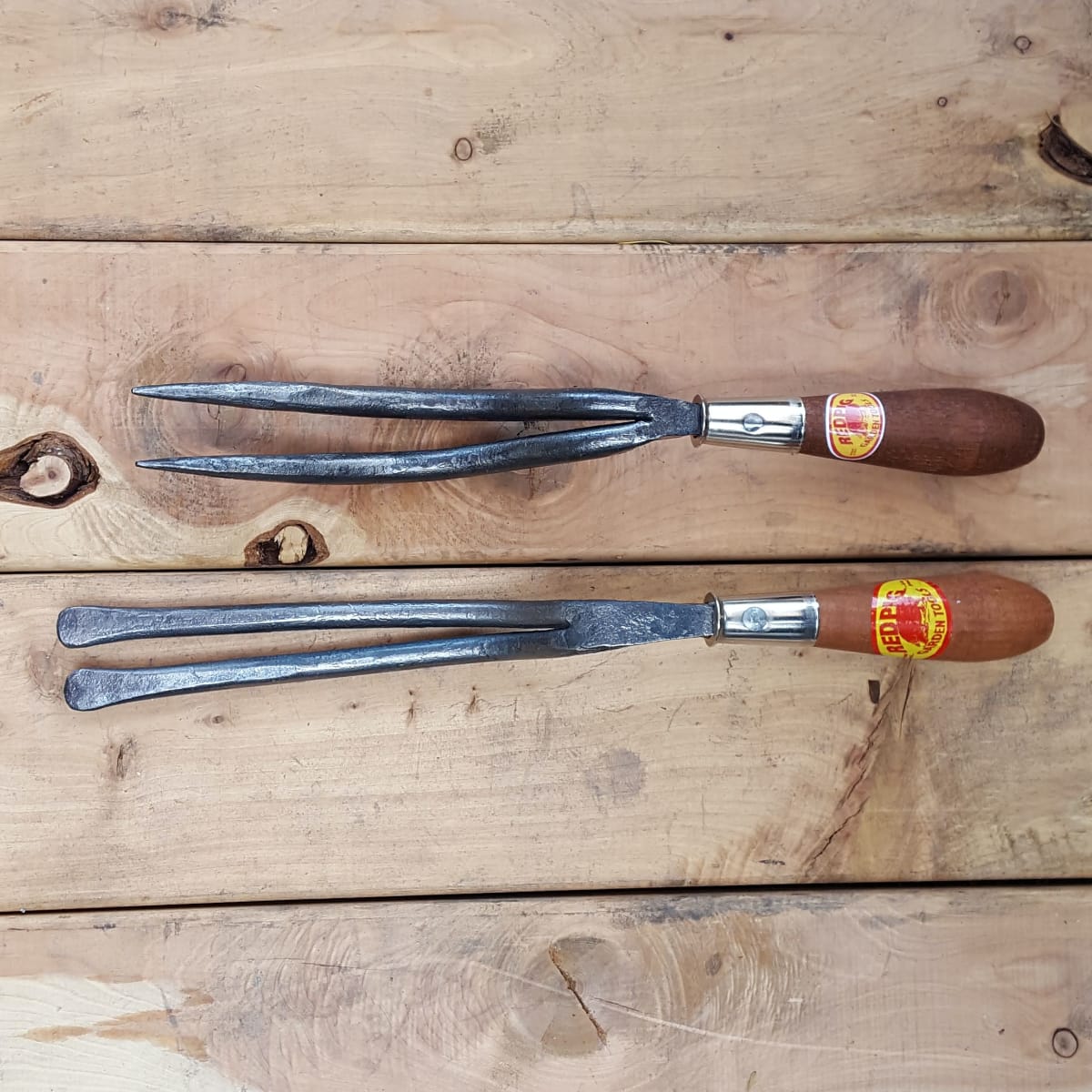 Compared to its cousin the Jekyll weeder, another two-pronged tool with pointed ends for piercing the ground.
