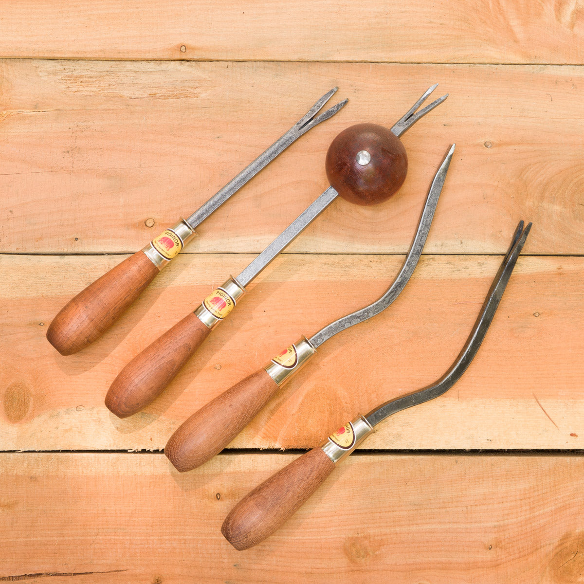 From left to right: Straight Forked Weeder, Ball Weeder, Weeding Spud, Dandelion Leverage Weeder