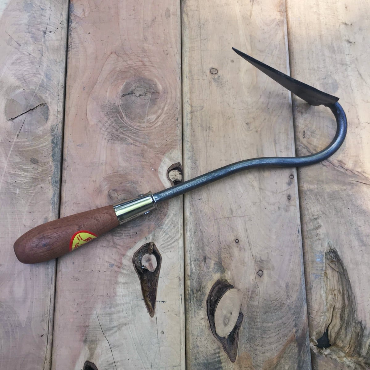 The V or Vee hoe is light but aggressive weeder. Use the point to flick out weeds and slice them with the narrow blade sharpened along both sides.