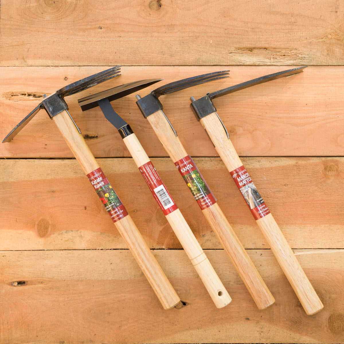 From left to right: Japanese Combo Hoe (Katate Kuwa), Japanese Triangle Hoe (Sankaku Kawa), Japanese Hand Rake (Kanta), Japanese Hand Mattock (Makoto Mattock)