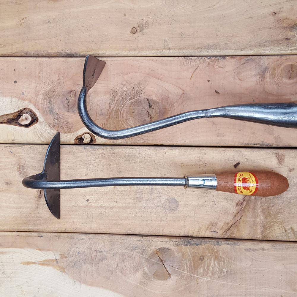 The half moon hoe can also be put on a long handle for an extra charge, seen above in the solid socket version, for use standing upright. Please call or email for the long handle version.