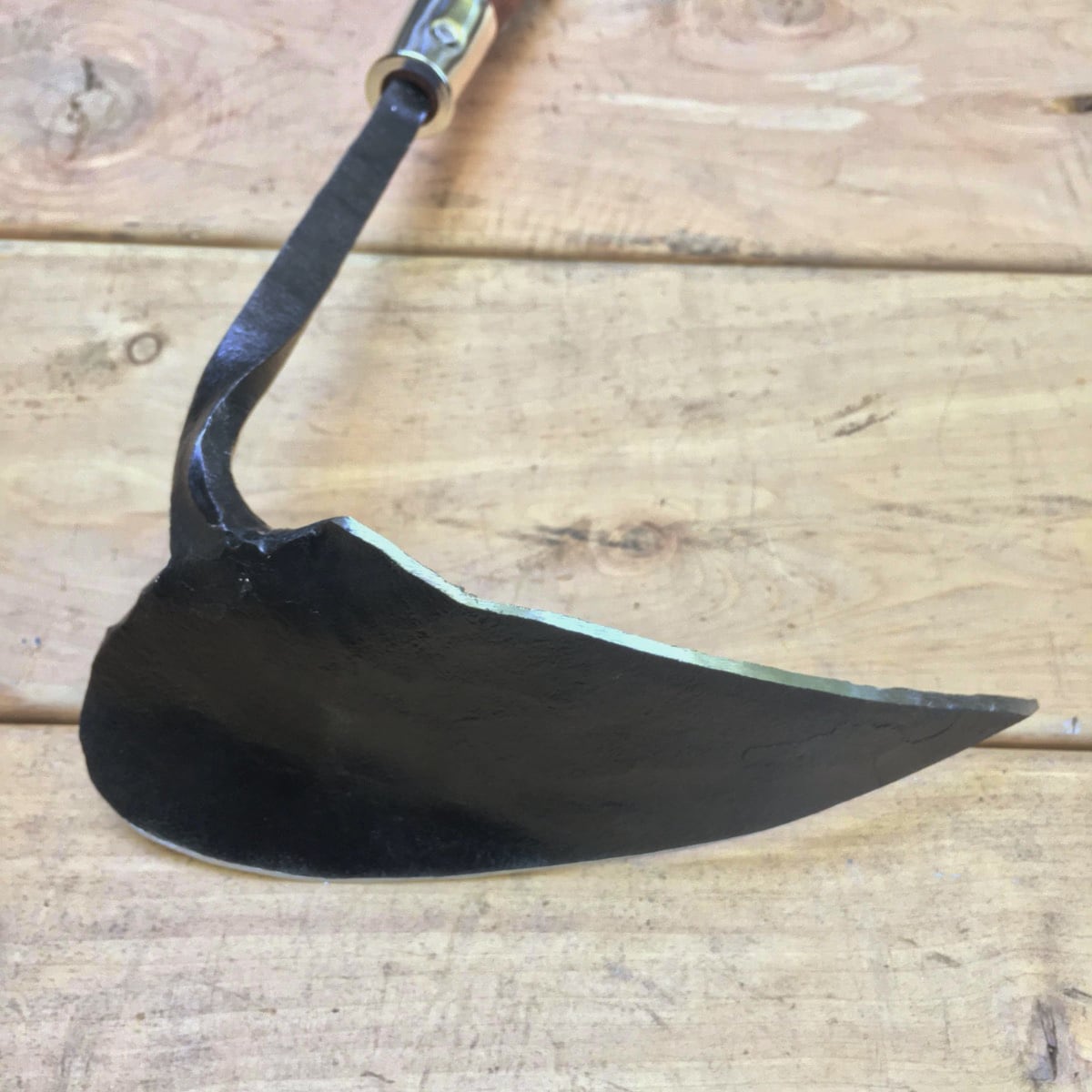 When flipped over the curved side of the blade can be used to fill in a just seeded furrow.