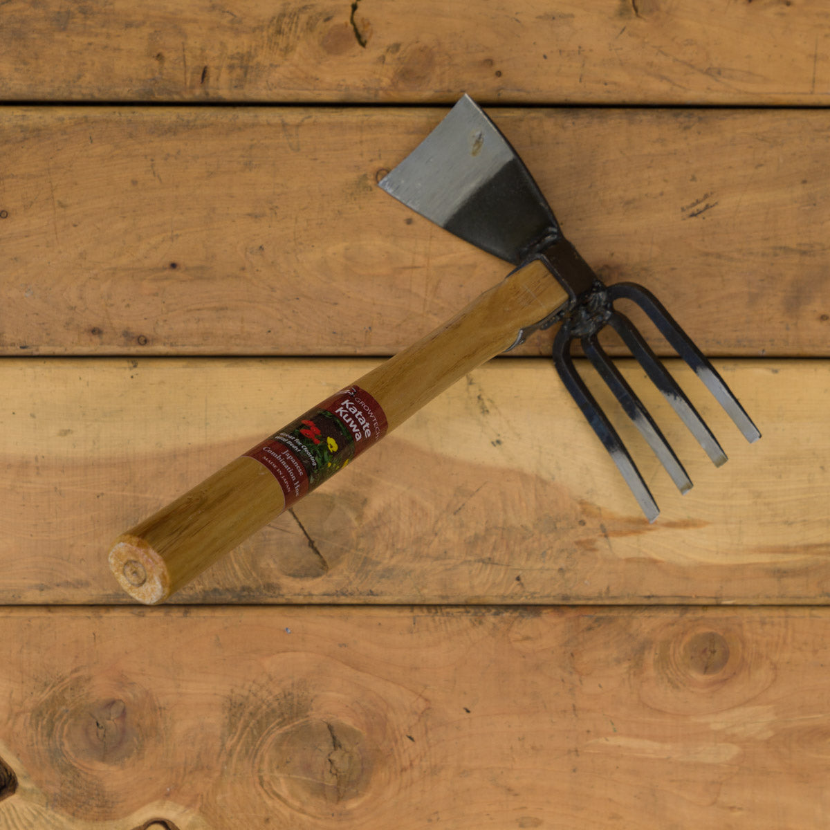This light-weight tool has a ~3" hoe on one side and a 4-tine cultivator on the other side.