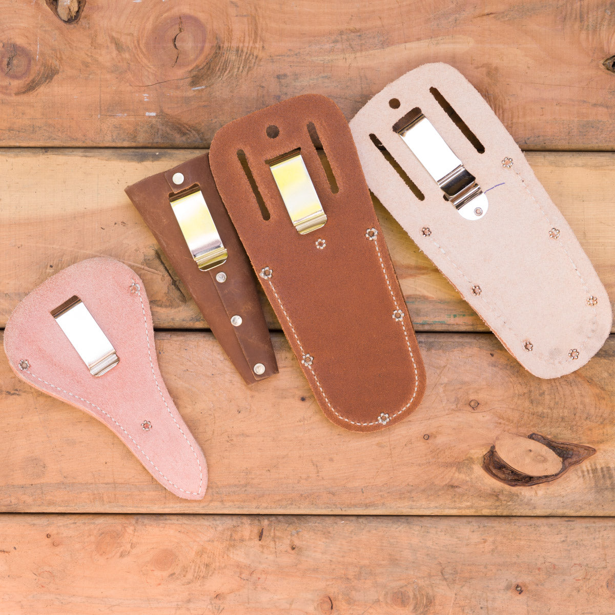 These four sheaths have metal clips at the back: scissor pouch, cone sheath, pruner pouch large, hand pruner pouch medium.
