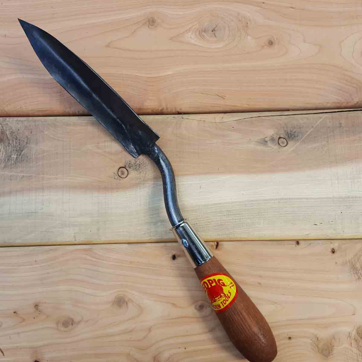 A narrow, sharp trowel for gardening on and around rock walls and pathways.