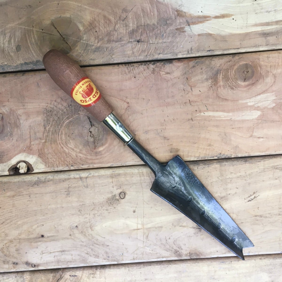 A seeder, a weeder, and a small trowel with a chiseled v-shaped front edge.