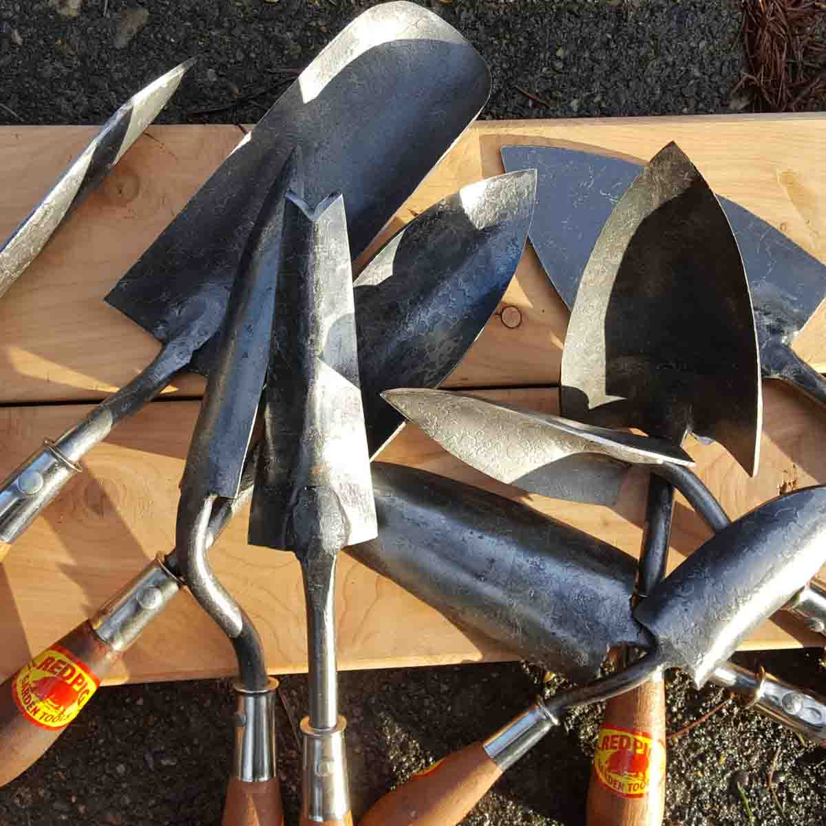 A pile of trowels for different purposes.