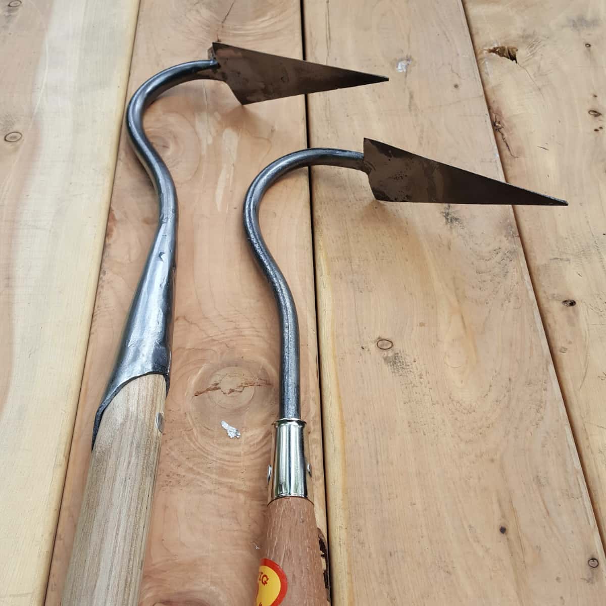 Side by side view of the short-handle V hoe (right) and full length long handled version version (left) with a solid socket and rivet.