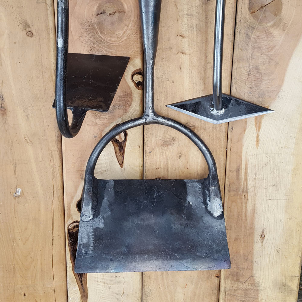 Every hoe has its use in the garden, here are the gooseneck, the Dutch push hoe, and the diamond scuffle hoe.