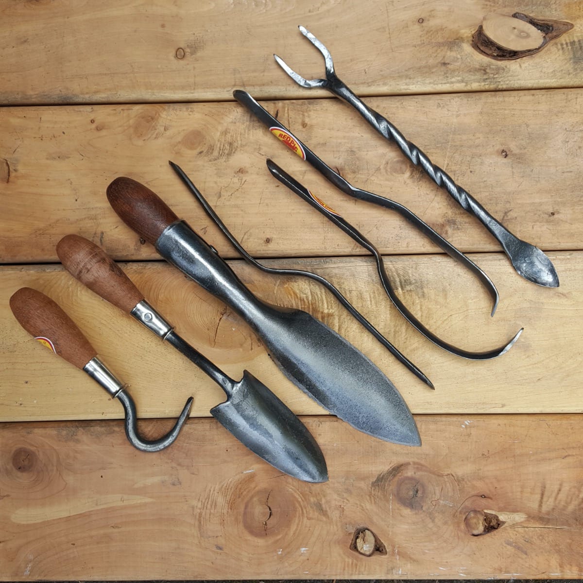 Another view of the collection of houseplant tools we make from left to right: houseplant cultivator, extra small trowel, Red Pig hori hori, three styles of widger, and houseplant cultivator.