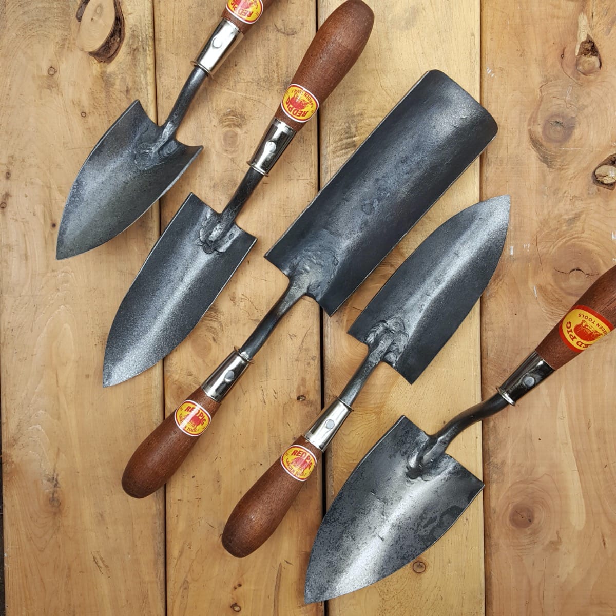The all-purpose trowels and transplanting trowels, at center, which are sharpened all the way to the top of the blade.