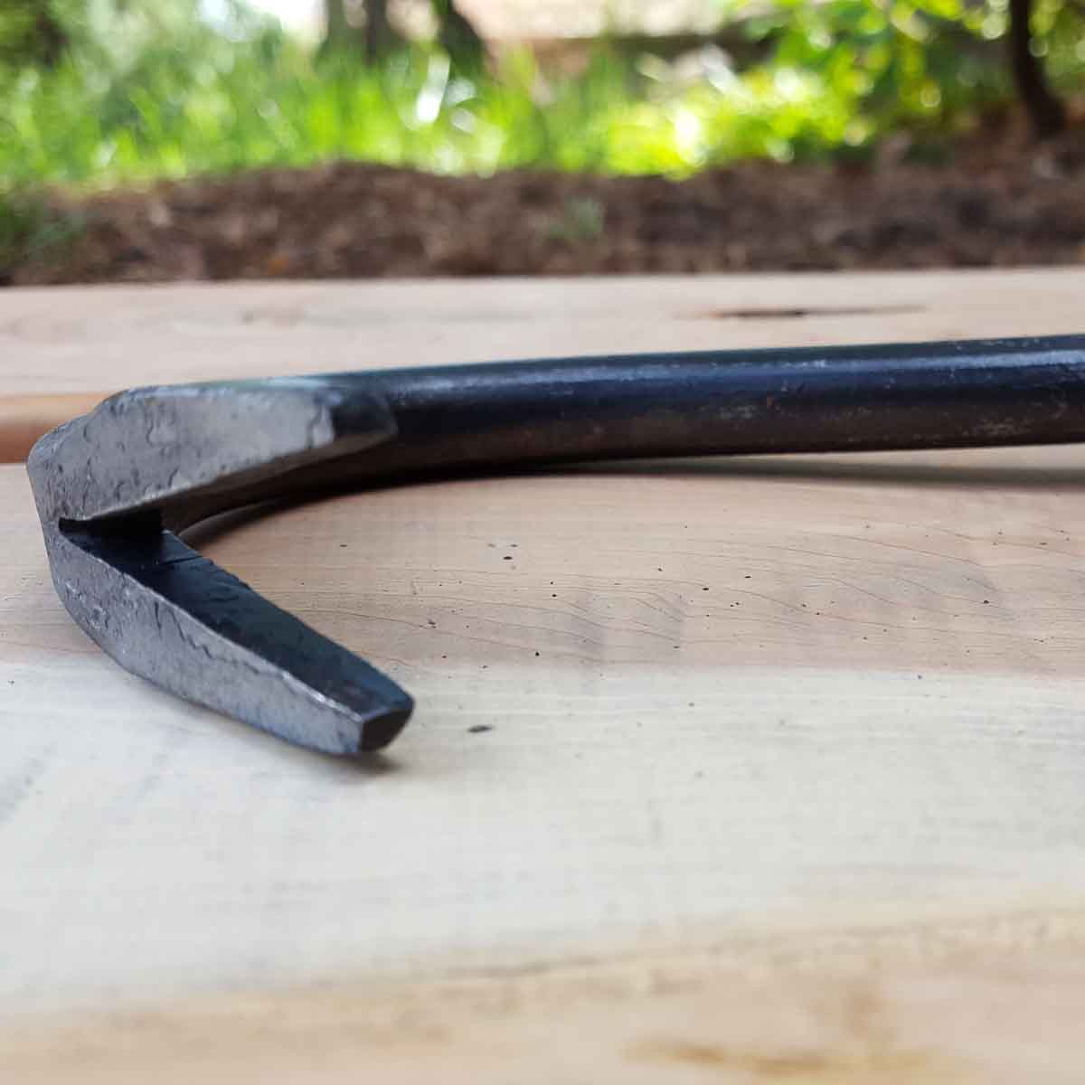 Grab the weed root at or just below the surface and pull it up and out.