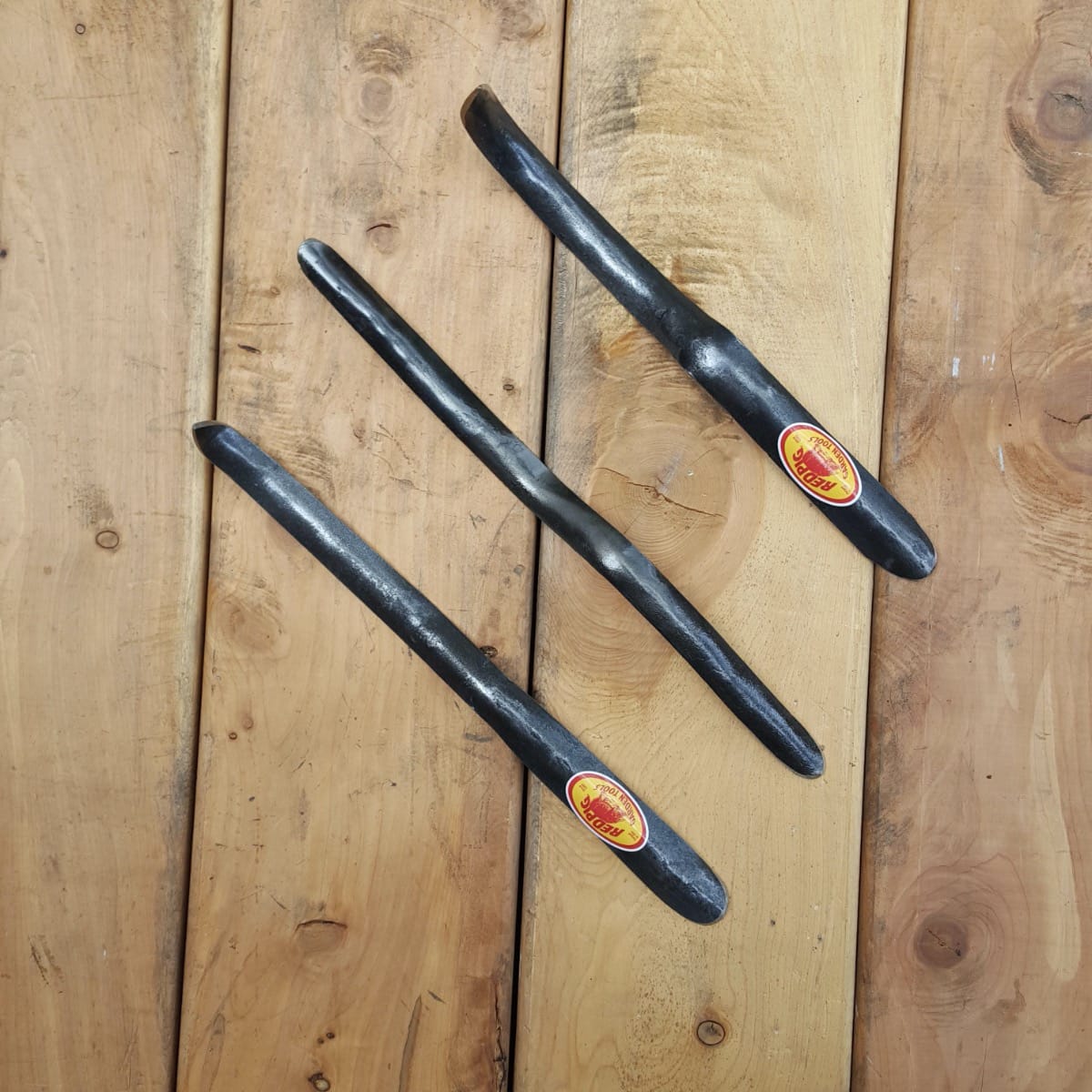 The traditional widger (option A) at center has two digging ends, while option B at left has a cultivating point and option C at right has an extended point for weeding.
